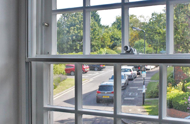 Vertical sliding secondary glazing