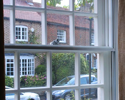 Vertical sliding secondary glazing